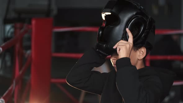 Boxer Kid at the Boxing Ring Putting Equipment on