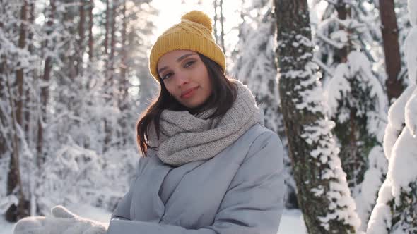 Portrait of a Beautiful Young Female in a Winter Forest a Cheerful Girl Posing and Looking at the