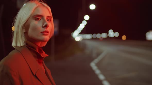 Young Woman Standing on Road in Night