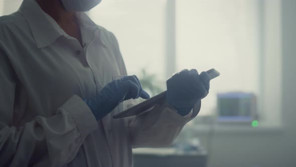 Woman Physician Typing Health Complaint on Tablet Closeup