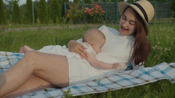 Little Baby Lies on Mom's Belly