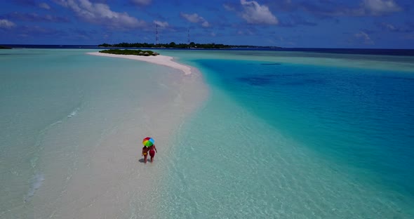 Young couple married on vacation enjoy life on beach on sunny white sandy 4K background