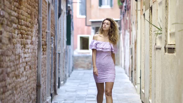 Young Tourist Woman Walking Up the Small Street in Sunny Day. Girl Spending Vacation in Europe