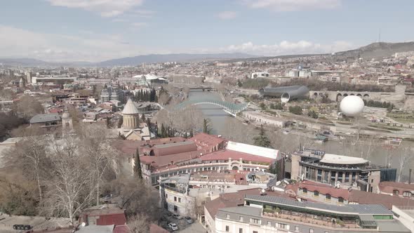 Aerial view of Tbilisi city central park and Bridge of Peace. Beautiful cityscape of old Tbilisi