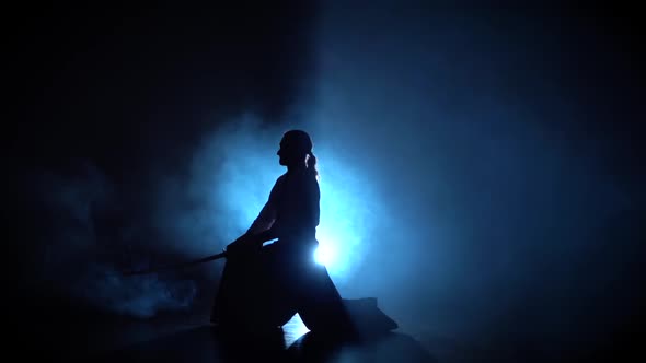 Silhouette Aikido Master Wearing Traditional Samurai Hakama Clothes Takes His Japanese Sword Out of