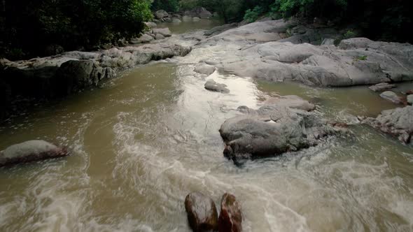 River with small waterfalls in dense tropical rainforest in Ko Samui, Thailand