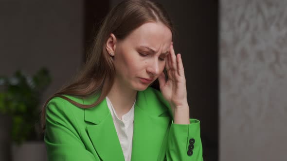 Young Woman Suffers From Headache Massaging Temples at Work