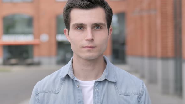 Portrait of Casual Young Man Outside Building