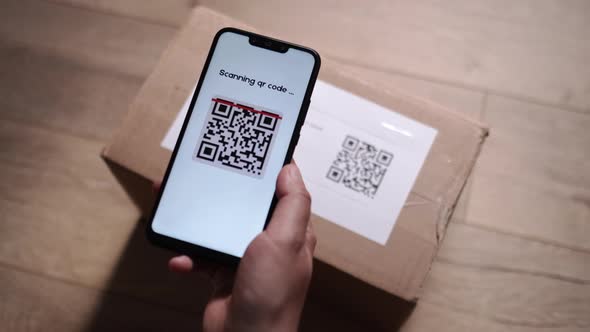 Scanning QR Code on Cardboard Parcel Using Cell Phone Indoor at Apartment