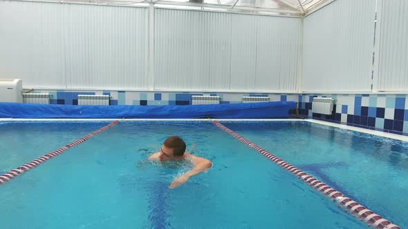 Young Man Swimming the Front Crawl in a Pool