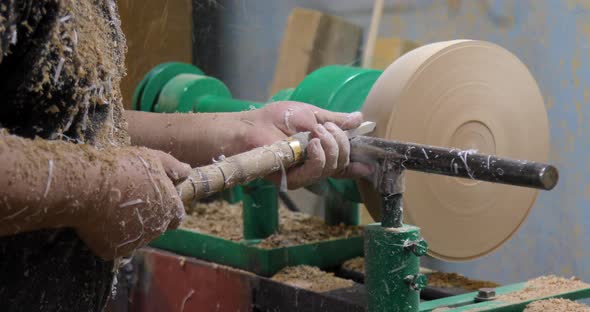 Closeup of carpenter turning wood on a lathe