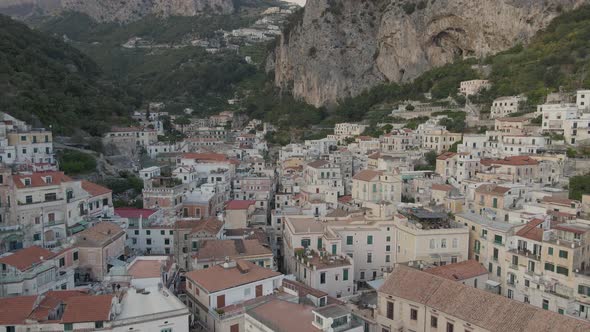 Amalfi City, Salerno province, Italy. Aerial view of old buildings under  steep cliffs of Monte Cerr