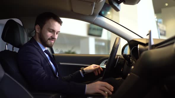 Stylish Businessman Wearing Suit Gets Behind the Wheel of Car He Bought.