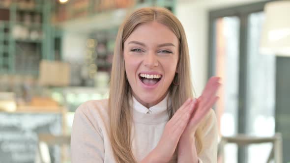 Portrait of Excited Young Woman Clapping, Cheering