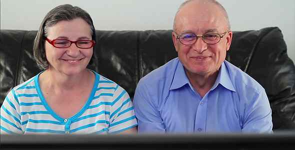 Happy Senior Couple Watching Television