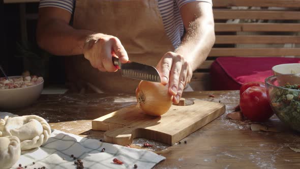 Men's Hands Cutting Onion on Wooden Board. Chef with Knife Cut Vegetables, Mexican or Latin American