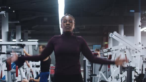 Sports in the Gym  Africanamerican Woman Jumping on One Spot