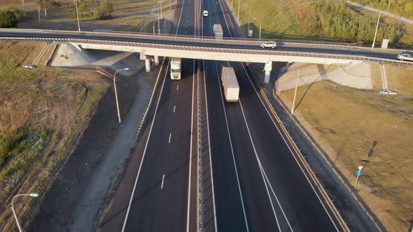 Aerial View. Interchange on the Intercity Highway. Cars and Trucks Travel in Different Directions