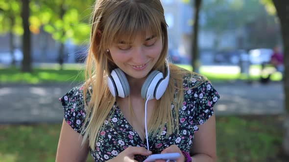 Surprised Woman Talking on the Phone with Headphones