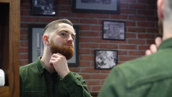 Very Handsome Young Man with a Red Beard in a Green Shirt