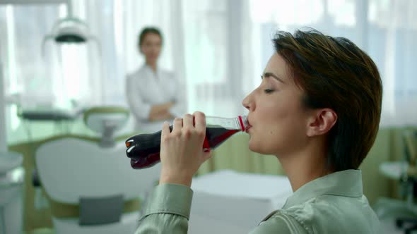 Girl Drinks Soda, Dentist Looks at Her Disapprovingly