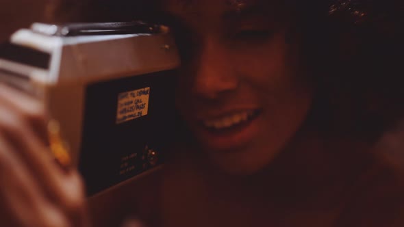 Woman With Afro Hair Looking Through Vintage 8Mm Camera