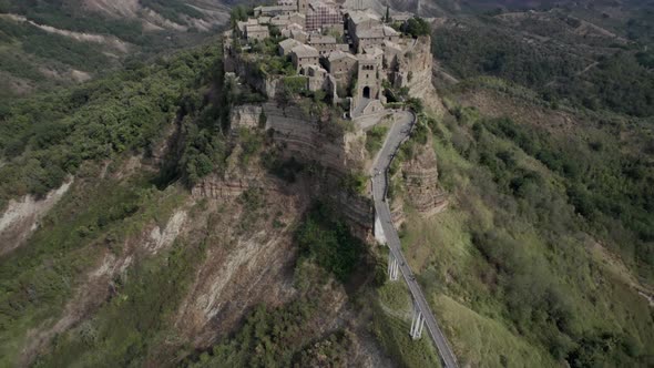 -PLANE: from crane ascending to bird's eye view-DESCRIPTION: video with drone over the civita di Ba