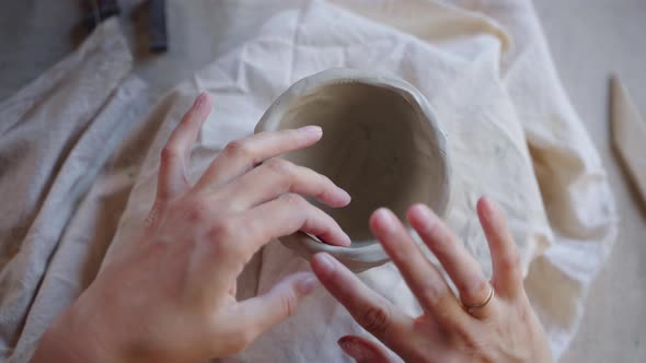Female Potter Modeling Ceramic Bowl