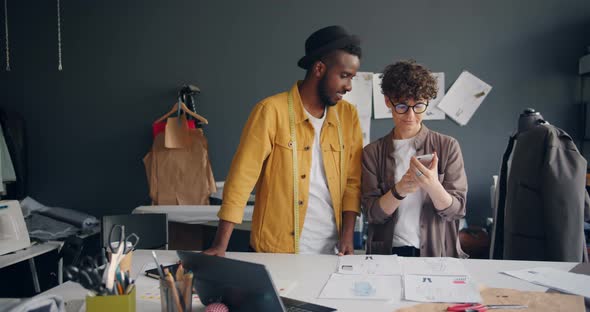 Tailors Taking Photo of Flat Lay Shooting Sketches with Smartphone Camera