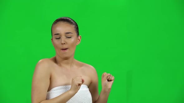 Girl in Towel Celebrating Her Triumph with Victory Dances on Green Screen