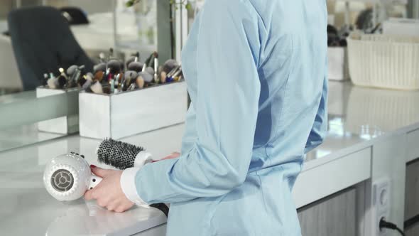 Close Up of a Cheerful Female Professional Hairdresser Smiling To the Camera