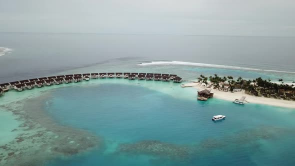 Water villas and yachts in the Maldives resort, a jungle and a blue lagoon in the middle of the ocea