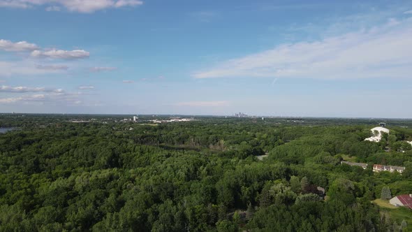 Beautiful aerial view over Hopkins, Minnesota, with pond nestled in between the trees on sunny day.