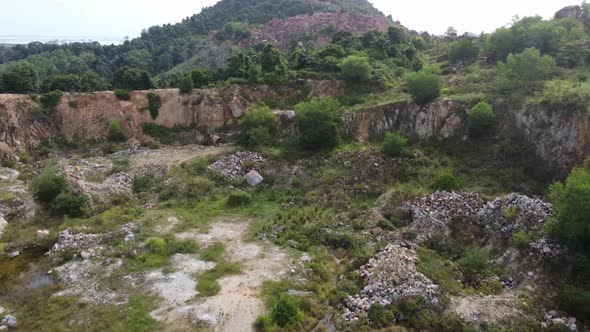 Aerial fly over abandoned rock quarry site.