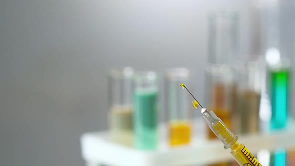 Close-up of a medical syringe filled with a drug vaccine against the virus.