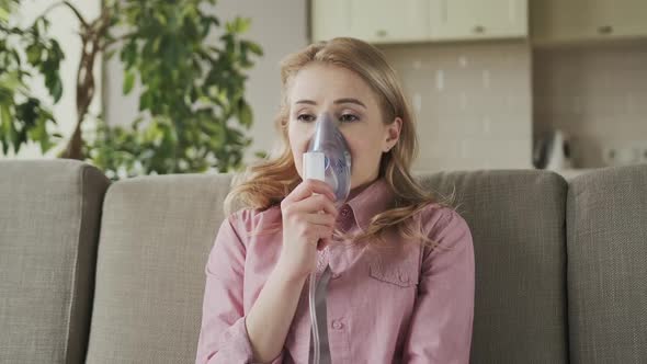 Sick Female Using Oxygen Mask at Home a 30s Woman Has Labored Breathing Treatment at Home