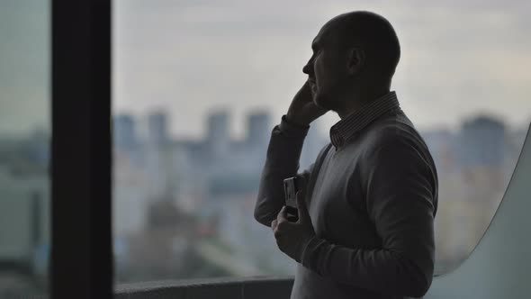 Silhouette of a Businessman Talking on the Phone