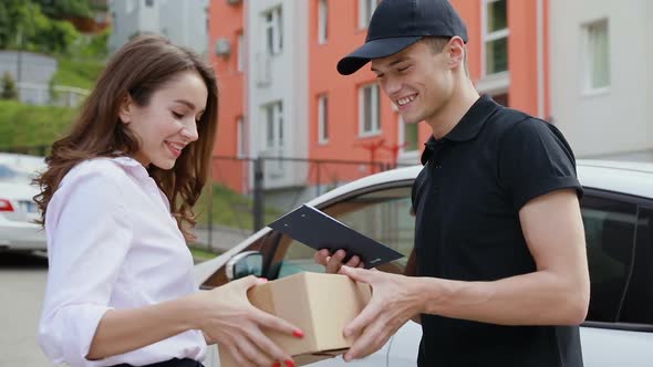 Delivery Service. Courier Delivering Box To Woman