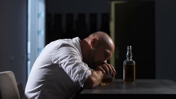 Lonely Depressed Adult Man Drinking Whisky at Home