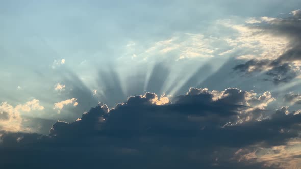 light beams emerging from the clouds in the sky