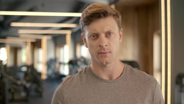 Sportsman Standing in Sport Club. Portrait of Handsome Bodybuilder at Gym.