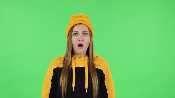 Portrait of Modern Frustrated Girl in Yellow Hat with Shocked Wow Face Expression. Green Screen