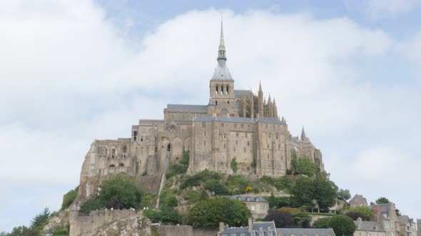 Panning on Mont-Saint-Michel island in  front of blue sky  Normandy France 4K 3840X2160 UHD video - 