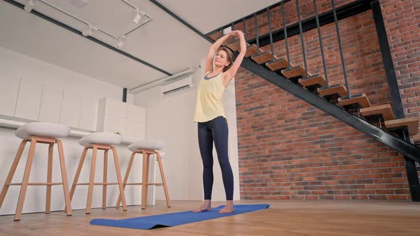 Cheerful Blonde Stretching at Home