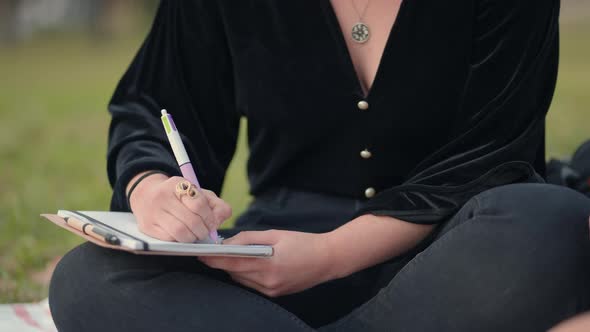 Hand Writing with a Pen on Notepad Close Up View