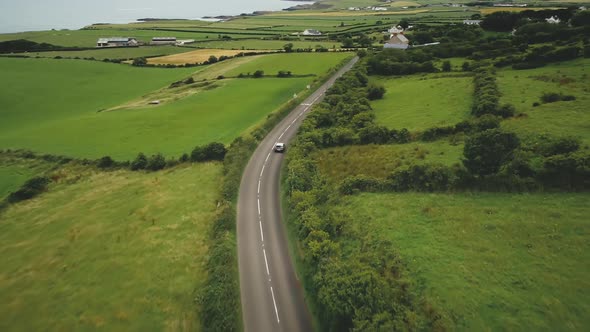 Irish Rural Road Aerial View: Green Meadows, Cottages and Hillside Farmlands. Picturesque Landscape