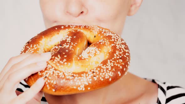 Close Up Face Young Woman Eating Pretzel