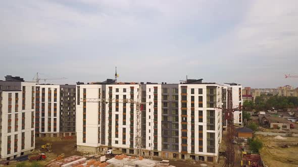 Aerial view of city residential area with high apartment buildings under construction.