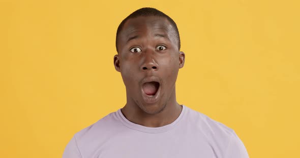 Studio Portrait of Amazed African American Man Shouting WOW