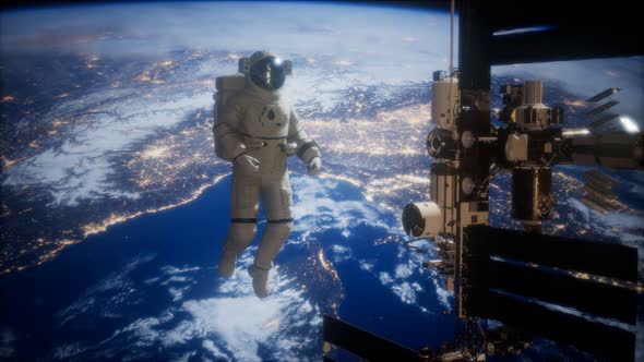 International Space Station and Astronaut in Outer Space Over the Planet Earth alt